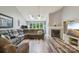 Open-concept living room featuring vaulted ceiling, skylights, hardwood floors and a fireplace at 14118 Yachtsman Harbor Dr, Charlotte, NC 28278