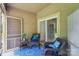 Relaxing screened-in patio with wicker furniture and an inviting blue rug at 14118 Yachtsman Harbor Dr, Charlotte, NC 28278