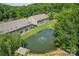 Scenic view of waterfront condos overlooking a pond with fountain feature and lush greenery at 14118 Yachtsman Harbor Dr, Charlotte, NC 28278