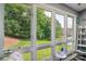 Bright sunroom with large windows offering picturesque views of the lush green lawn at 14118 Yachtsman Harbor Dr, Charlotte, NC 28278