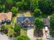 Aerial view of a two-story brick home with mature trees, a long driveway, and a two-car garage at 1465 Porters Ct, Concord, NC 28025