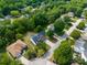 Aerial view of a well-maintained two-story home with a large driveway and surrounding greenery at 1465 Porters Ct, Concord, NC 28025