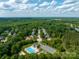 Scenic aerial view of a neighborhood featuring a pool, playground, and community parking at 1465 Porters Ct, Concord, NC 28025