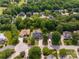 Aerial view of a residential neighborhood with mature trees, well-maintained lawns, and multiple houses at 1465 Porters Ct, Concord, NC 28025