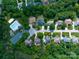An aerial community view with homes, a community pool, walking trails, and lush green trees at 1465 Porters Ct, Concord, NC 28025