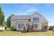 View of the back exterior with a wooden deck and large windows for natural light at 1465 Porters Ct, Concord, NC 28025