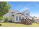 View of back exterior shows wooden deck, beige siding, gray roof, and beautiful lawn at 1465 Porters Ct, Concord, NC 28025