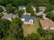 Aerial view of a home with a deck and a spacious lawn, surrounded by trees and lush greenery at 1465 Porters Ct, Concord, NC 28025