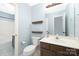 Bathroom with brown vanity, toilet, and shower/tub combo featuring a blue color scheme at 1465 Porters Ct, Concord, NC 28025