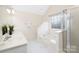 Bathroom with bathtub, shower, and bright white vanity area with great lighting and marble floors at 1465 Porters Ct, Concord, NC 28025