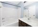 Bathroom with bathtub/shower combo, brown vanity and blue walls with decorative mirror at 1465 Porters Ct, Concord, NC 28025