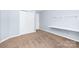 Light blue bedroom featuring neutral carpet, a built-in desk, and a closet at 1465 Porters Ct, Concord, NC 28025