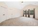 Bedroom featuring three windows with natural light and neutral carpet at 1465 Porters Ct, Concord, NC 28025