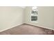 Bright bedroom featuring neutral carpet and a bright arched window at 1465 Porters Ct, Concord, NC 28025