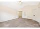 Bedroom with neutral carpet, a ceiling fan, and double door closets at 1465 Porters Ct, Concord, NC 28025