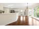 Open-concept dining room features hardwood floors, large windows, and stylish lighting fixture at 1465 Porters Ct, Concord, NC 28025