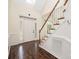 Bright foyer with hardwood floors, white wainscoting, decorative glass door and staircase with wooden banister at 1465 Porters Ct, Concord, NC 28025