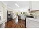 Modern kitchen with stainless steel appliances, white cabinets, granite countertops, and hardwood floors at 1465 Porters Ct, Concord, NC 28025