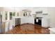 Modern kitchen with stainless steel appliances, white cabinets, granite countertops, and hardwood floors at 1465 Porters Ct, Concord, NC 28025