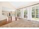 Bright and spacious living room with large windows, hardwood and carpet flooring, and backyard views at 1465 Porters Ct, Concord, NC 28025