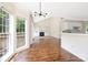 Bright open-concept living room with hardwood floors, vaulted ceiling, fireplace, built-ins, and large windows at 1465 Porters Ct, Concord, NC 28025