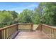 Close-up of the wooden deck and railing showing the expansive lawn and landscaping at 1465 Porters Ct, Concord, NC 28025