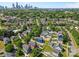 Picturesque neighborhood with mature trees and colorful homes with the Charlotte skyline in the distance at 1821 Ethel Guest Ln, Charlotte, NC 28206