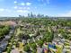 Beautiful aerial view of a neighborhood with mature trees and Charlotte skyline at 1821 Ethel Guest Ln, Charlotte, NC 28206