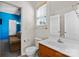 Bathroom with white toilet and vanity, bright natural light, and a view into a living area at 1821 Ethel Guest Ln, Charlotte, NC 28206