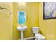 Bathroom featuring a pedestal sink, toilet, and modern fixtures in a bright, clean space at 1821 Ethel Guest Ln, Charlotte, NC 28206