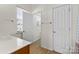 Bright bathroom with white cabinets, a mirror, and natural light with tile floors at 1821 Ethel Guest Ln, Charlotte, NC 28206