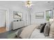 Bright bedroom featuring soft gray walls, a comfortable bed, and tasteful decor with ample storage at 1821 Ethel Guest Ln, Charlotte, NC 28206