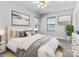 Inviting bedroom featuring a comfortable bed, modern decor, and natural light from multiple windows at 1821 Ethel Guest Ln, Charlotte, NC 28206