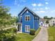 Charming blue home with well-maintained landscaping, a cozy front porch, and a paved driveway at 1821 Ethel Guest Ln, Charlotte, NC 28206