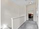 Hallway with gray carpet, white walls, and views into a bedroom at 1821 Ethel Guest Ln, Charlotte, NC 28206