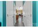 Hallway view leading to a bright, well-lit kitchen and dining area with hardwood floors at 1821 Ethel Guest Ln, Charlotte, NC 28206
