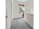 Hallway with neutral walls and carpet, a window with sunlight coming through, and white trim at 1821 Ethel Guest Ln, Charlotte, NC 28206
