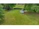 Aerial view of a backyard featuring a shed, mature trees and well-manicured lawn at 195 Antler Dr, Statesville, NC 28625