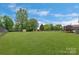 A large backyard boasts mature trees and green grass, perfect for outdoor enjoyment at 195 Antler Dr, Statesville, NC 28625