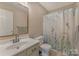 Cozy bathroom featuring a vanity, toilet, and bathtub with a decorative shower curtain at 195 Antler Dr, Statesville, NC 28625