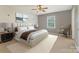 Bright bedroom with a queen-size bed, a decorative rug, and a cozy chair at 195 Antler Dr, Statesville, NC 28625