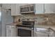 Bright kitchen with stainless steel appliances, light countertops, and white cabinetry at 195 Antler Dr, Statesville, NC 28625