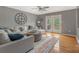 Inviting living room features hardwood floors, neutral paint, and a large sofa for relaxing at 195 Antler Dr, Statesville, NC 28625