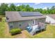Aerial view of the home with solar panels, deck, siding, and manicured lawn at 206 Pine Meadow St, Hickory, NC 28601