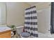 Bathroom featuring a tub-shower combo with a striped curtain, tile floors, and a vanity sink at 206 Pine Meadow St, Hickory, NC 28601