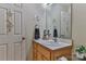 Bathroom vanity with a wood cabinet, a mirror, and decorative hardware at 206 Pine Meadow St, Hickory, NC 28601