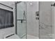 Sleek bathroom features a frameless glass shower with marble-style tiling, a toilet, and matte black fixtures at 206 Pine Meadow St, Hickory, NC 28601