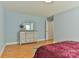 Comfortable bedroom features neutral walls, wood laminate flooring, and a view of a wooden dresser and closet at 206 Pine Meadow St, Hickory, NC 28601