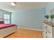Spacious bedroom features neutral walls, wood laminate flooring, and a wooden dresser with greenery at 206 Pine Meadow St, Hickory, NC 28601