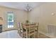 Charming dining area featuring a wooden table, seating for six, and a view of the outdoor deck at 206 Pine Meadow St, Hickory, NC 28601